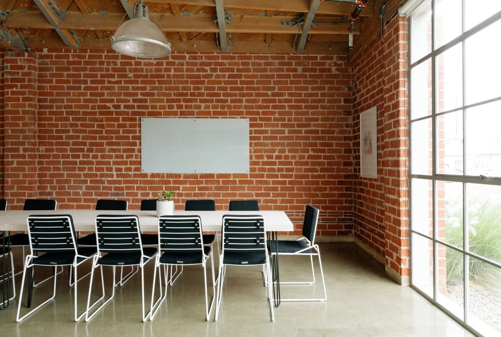 A meeting room with a long table and chairs