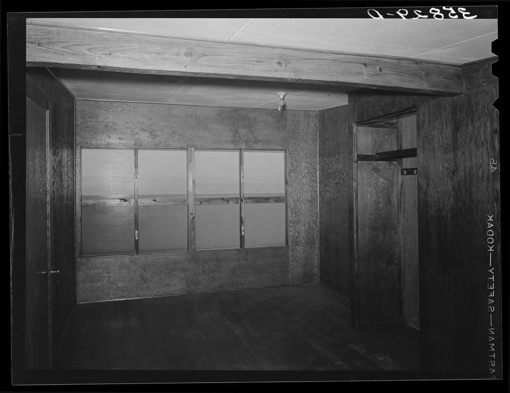 A guest room with two beds and a window